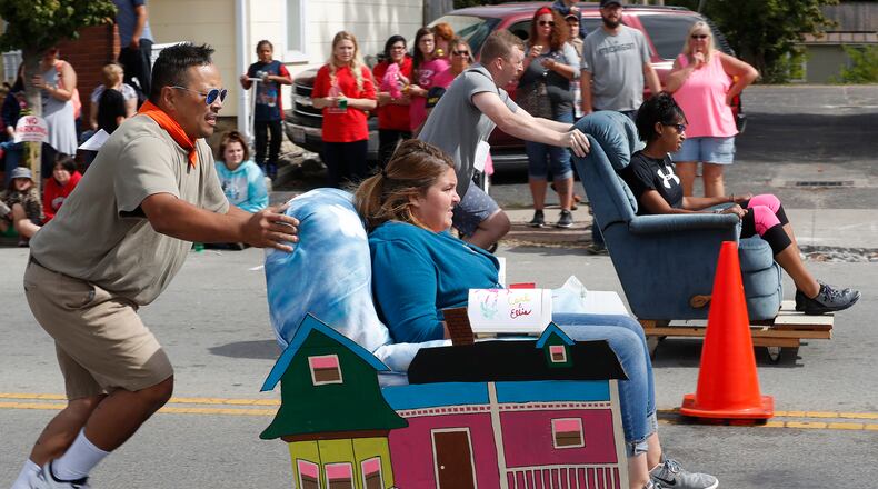 Cliff and Barbara Foght, closest lane, races Ethan Reynolds and Stephanie Willis in the Chair Races Sunday at the New Carlisle Heritage of Flight Festival. Bill Lackey/Staff
