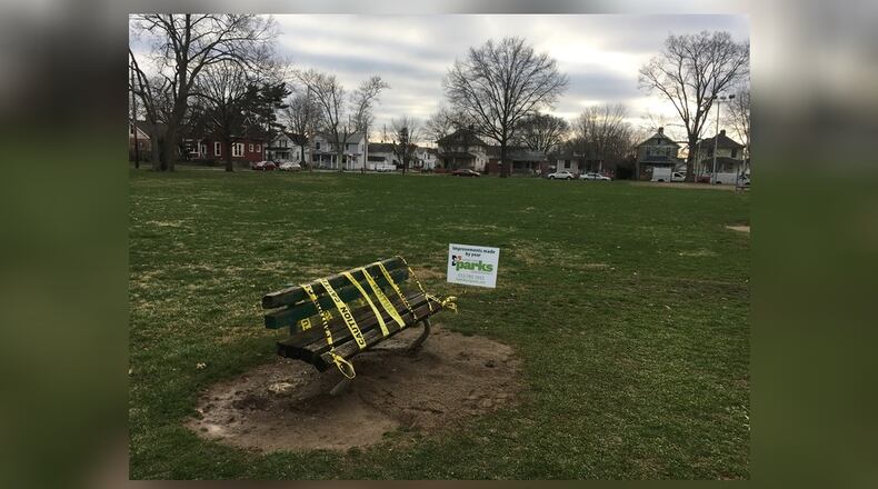 Caution tape covers a bench in Lindenwald Park, where police investigated the report of a dead body on April 2.