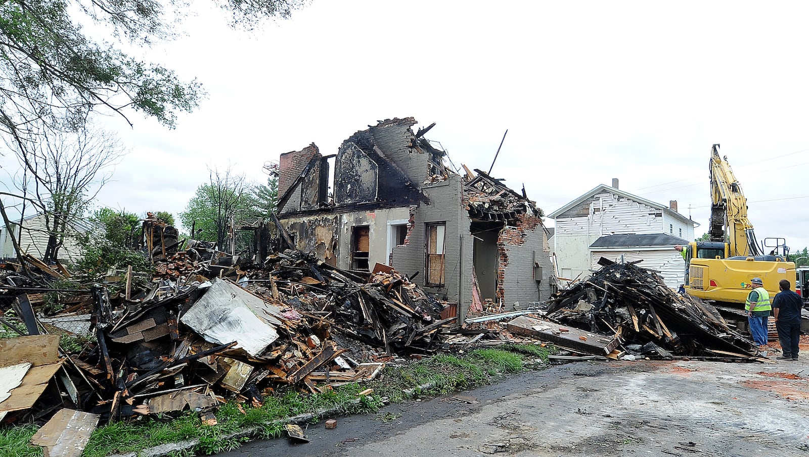 Fire destroyed three houses on East Fourth Street in Dayton Monday morning, June 6, 2024 resulting in an emergency demolition order. A cadaver dog was brought in from Columbus to check the ruins as a precaution. MARSHALL GORBY\STAFF