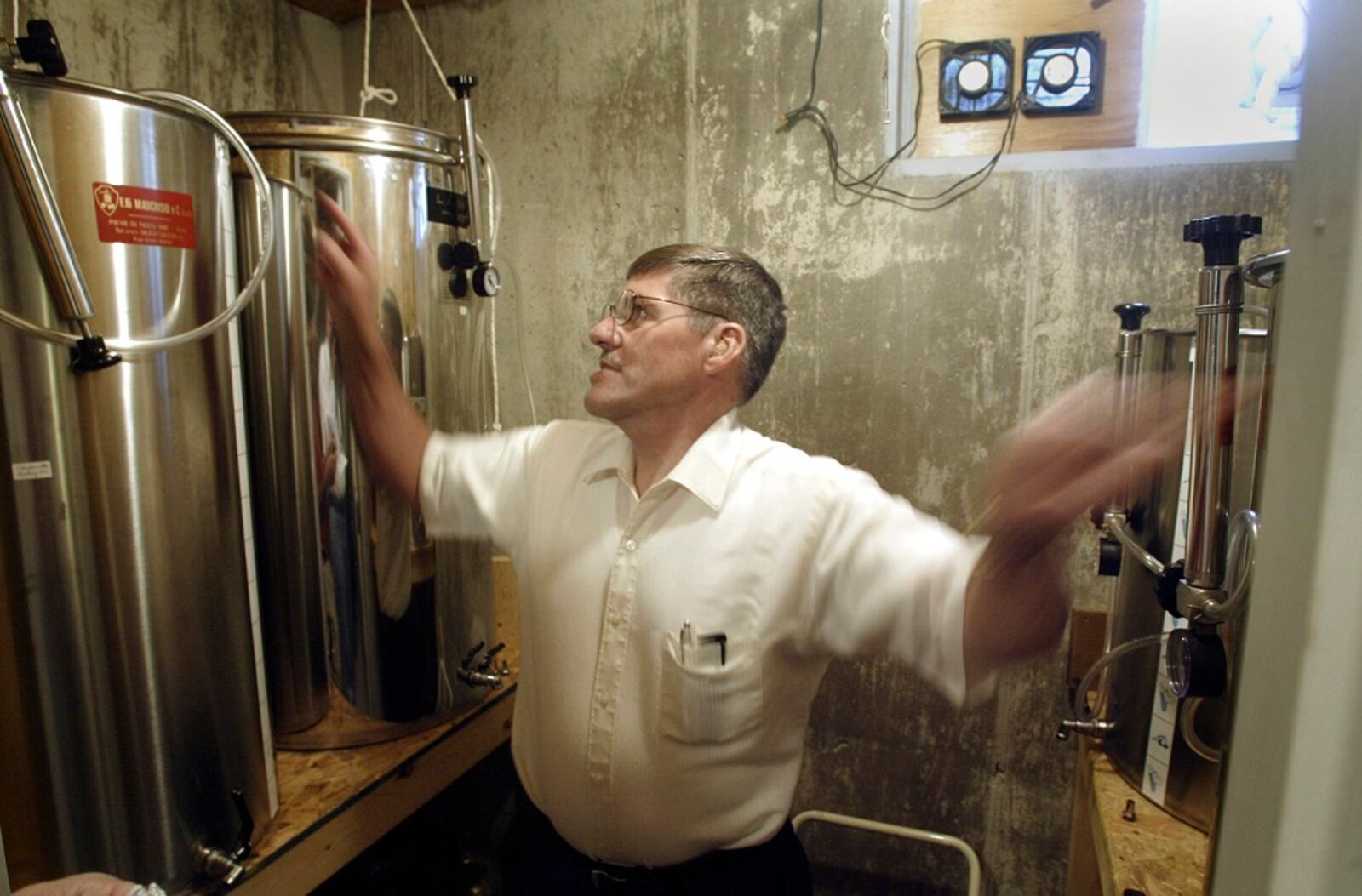In this file photo from 2005, Jim Brandeberry looks over the fermentation tanks he used to make wine in what was then a climate-controlled basement room in his southern Clark County home.
