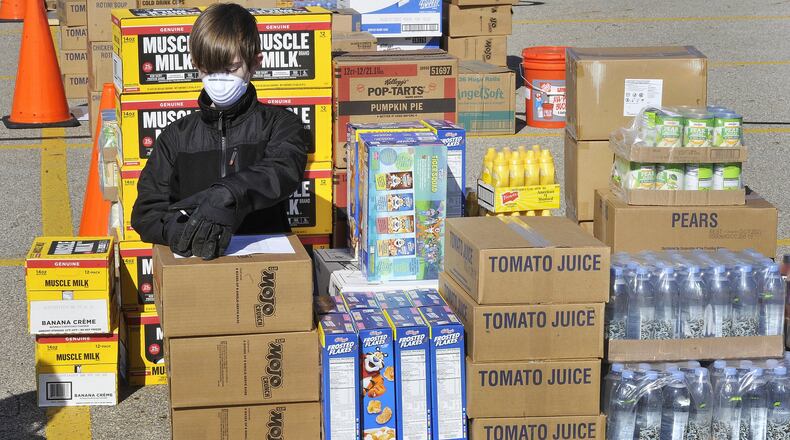 Theo Kladitis was helping pack food for 10 area churches on Thursday morning in the parking lot of Christian Life Center church. Convoy of Hope brought 40,000 pounds of food to the church to disperse to other churches and community members in need. Theo and his dad Paul are members of the Christian Life Center. MARSHALL GORBYSTAFF