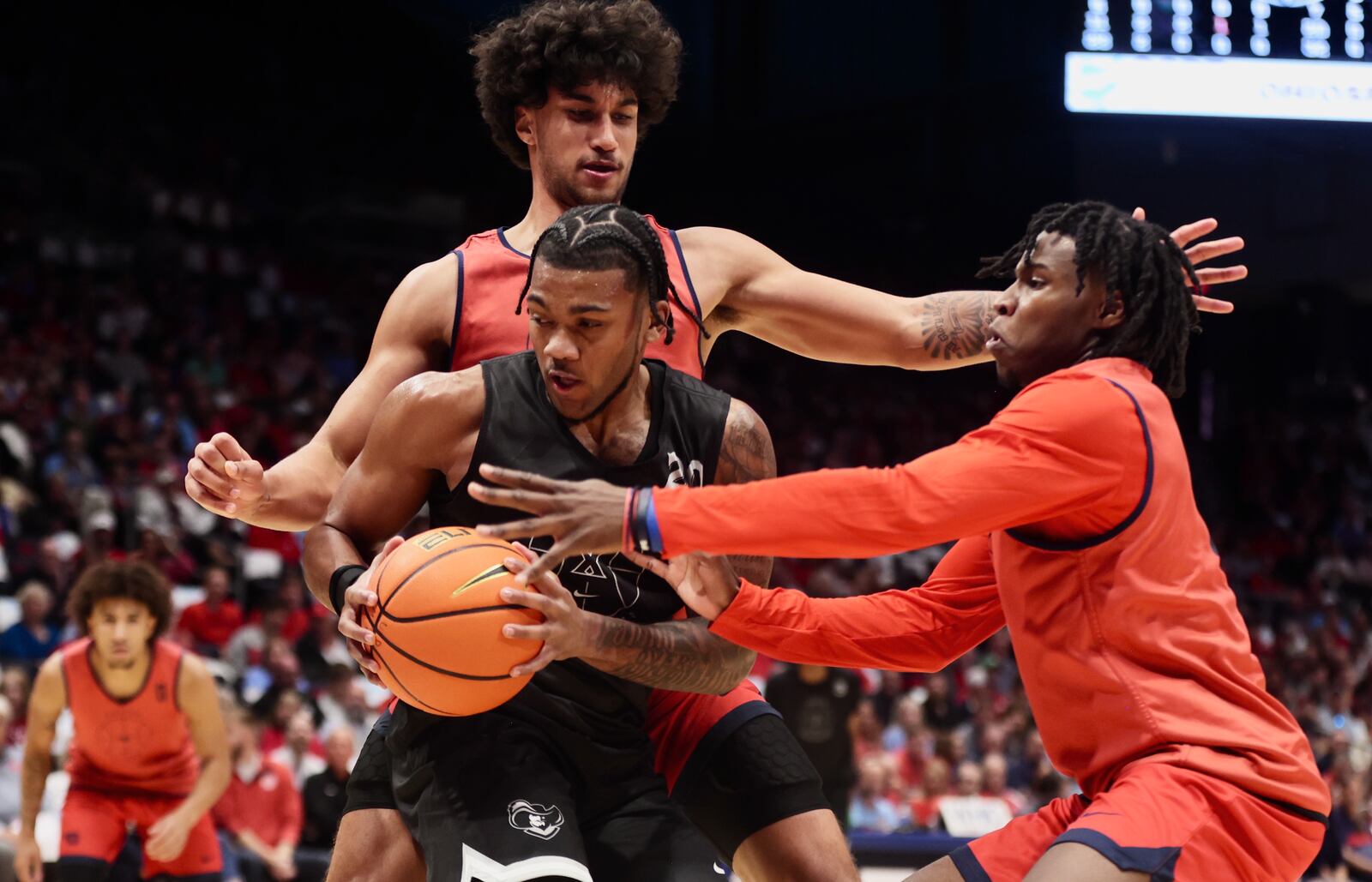 Dayton's Malachi Smith, right, and Nate Santos apply pressure against Xavier in an exhibition game on Sunday, Oct. 20, 2024, at UD Arena. David Jablonski/Staff