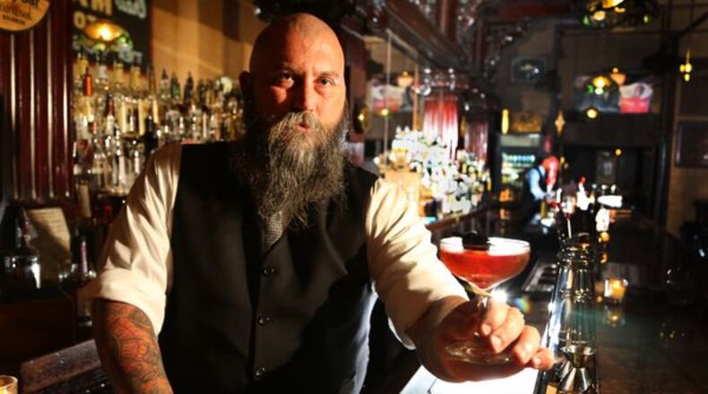 Century Bar co-owner Joseph Head shows off the bar’s cocktail called “Remember the Maine,” made with Rye Whiskey, Cherry Liqueur, Bitters, Bulliet Rye and Sweet Vermouth. Staff file photo JIM WITMER/STAFF