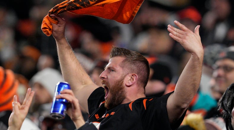 A fan cheers in the first half of an NFL wild-card playoff football game between the Baltimore Ravens and Cincinnati Bengals in Cincinnati, Sunday, Jan. 15, 2023. (AP Photo/Jeff Dean)