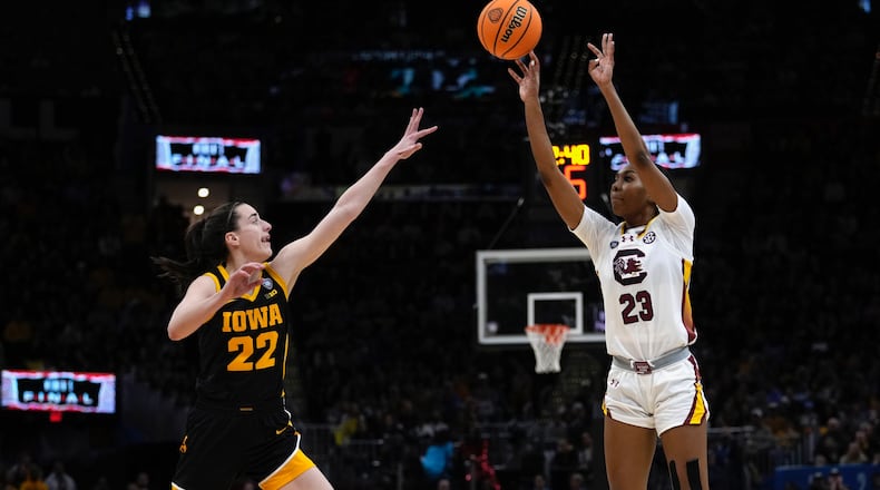 South Carolina guard Bree Hall (23) shoots over Iowa guard Caitlin Clark (22) during the second half of the Final Four college basketball championship game in the women's NCAA Tournament, Sunday, April 7, 2024, in Cleveland. (AP Photo/Carolyn Kaster)