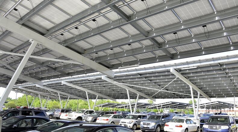 With use of solar power growing nationwide, Hamilton utility officials on Wednesday will hold a public input session on whether to purchase solar power from residents. Businesses are invited to attend as well. In this photo, the Assurant company has more than 6,000 solar panels at its Springfield location, with its parking lot covered by a series of carports topped by solar panels. BILL LACKEY/STAFF 2015