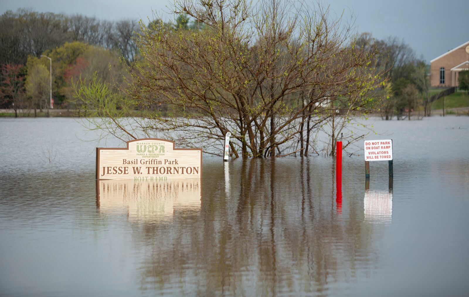 Signs at Basil Griffin Park in Bowling Green, Ky., stand in flooded waters on Friday, April 4, 2025, after excessive rainfall Thursday into Friday drenched southcentral Kentucky with more than four and a half inches of rain. (Grace McDowell /Daily News via AP)