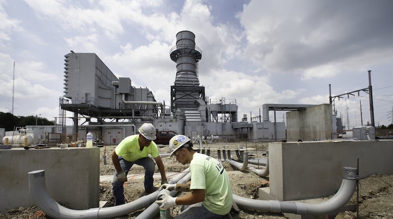 In this 2013 Dayton Daily News file photo, electricians run conduit into a $20 million battery array that was under construction at Dayton Power & Light’s Tait generating station in Moraine. AES Energy Storage, a subsidiary to the parent company of DPL Inc. built the array of 800,000 D-size batteries to provide frequency regulation to power service in the region and beyond. CHRIS STEWART / STAFF FILE PHOTO