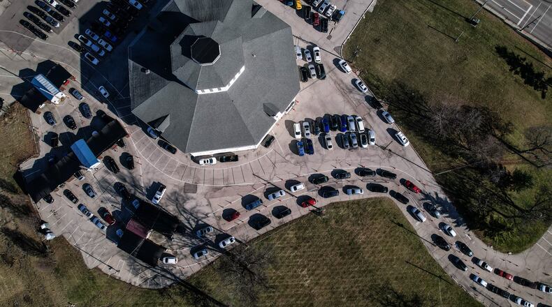 COVID-19 testing lines rap around the landmark "roundhouse" barn at the old Montgomery County Fairgrounds Tuesday Jan. 4, 2022. People who want to be tested have picked-up the last couple of weeks on the old fairground site. JIM NOELKER/STAFF