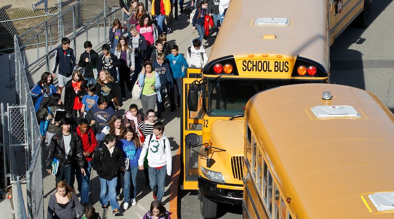 Children board buses at Ferguson Middle School.