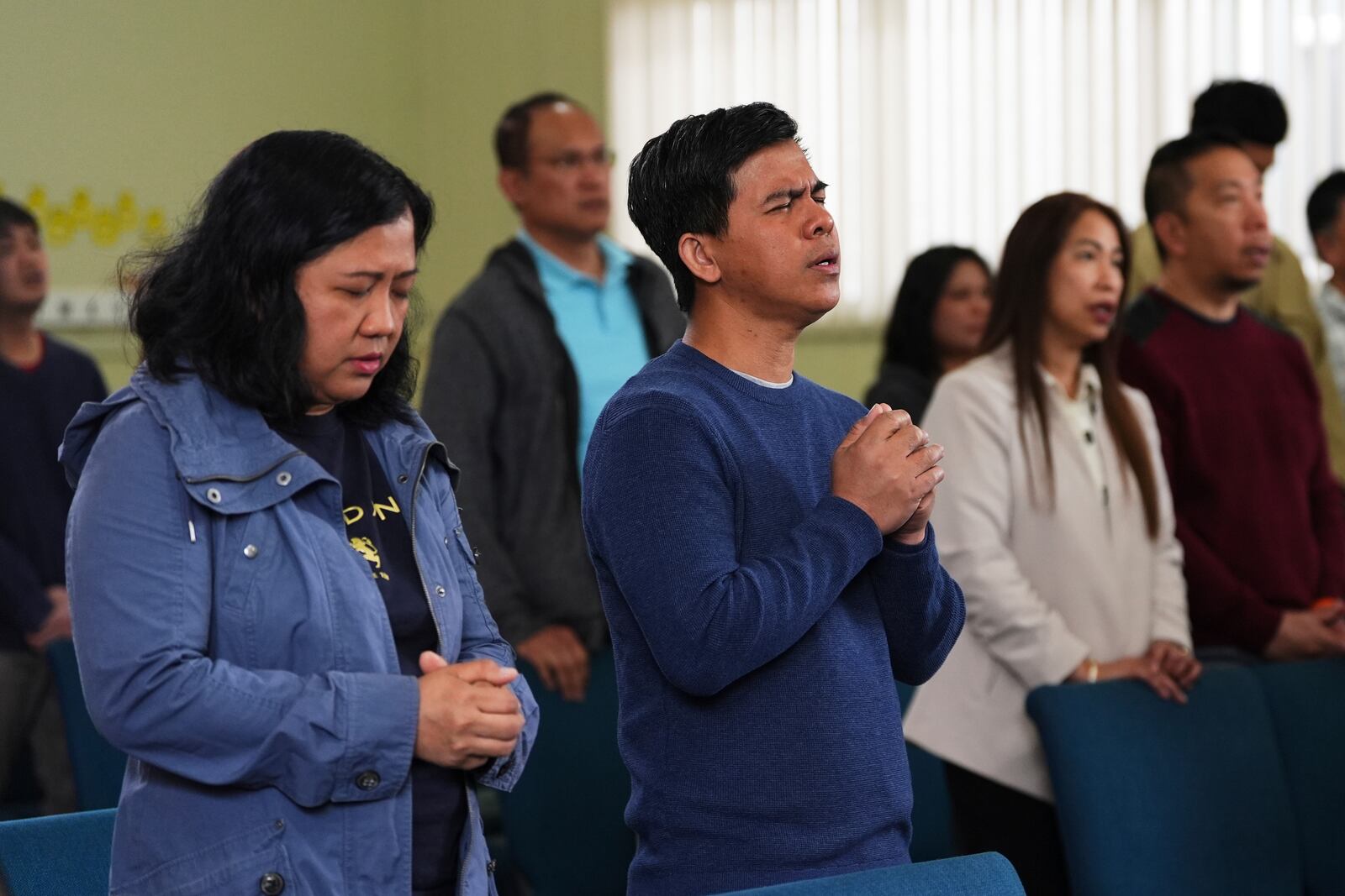 Adonis Quita, center, who witnessed the event, sings during a worship service at the Filipino Fellowship Baptist Church the day after a driver killed multiple people during a Filipino community festival Sunday, April 27, 2025, in Vancouver, British Columbia. (AP Photo/Lindsey Wasson)