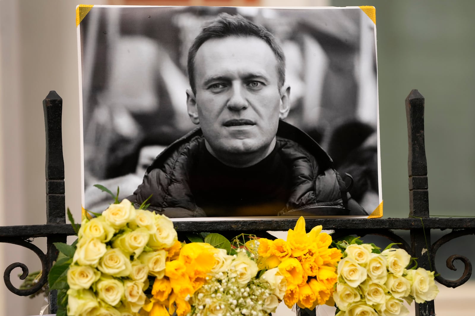 Flowers and a picture are left as a tribute to Russian politician Alexi Navalny, near to the Russian Embassy in London, Sunday, Feb. 18, 2024. Navalny, who crusaded against Russian corruption and staged massive anti-Kremlin protests as President Vladimir Putin's fiercest foe, died Friday in the Arctic penal colony where he was serving a 19-year sentence, Russia's prison agency said. He was 47. (AP Photo/Kirsty Wigglesworth)