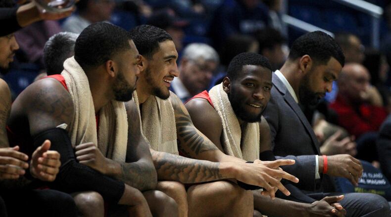 Dayton’s Trey Landers, Obi Toppin and Jalen Crutcher talk on the bench late in a victory against Rhode Island on Wednesday, March 4, 2020, at the Ryan Center in Kingston, R.I. David Jablonski/Staff