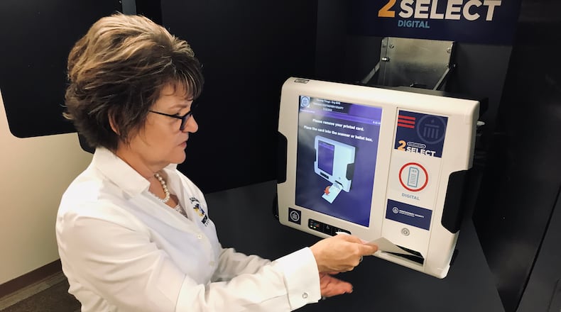 Director of the Montgomery County Board of Elections Jan Kelly demonstrates how to use the county’s new voting equipment.