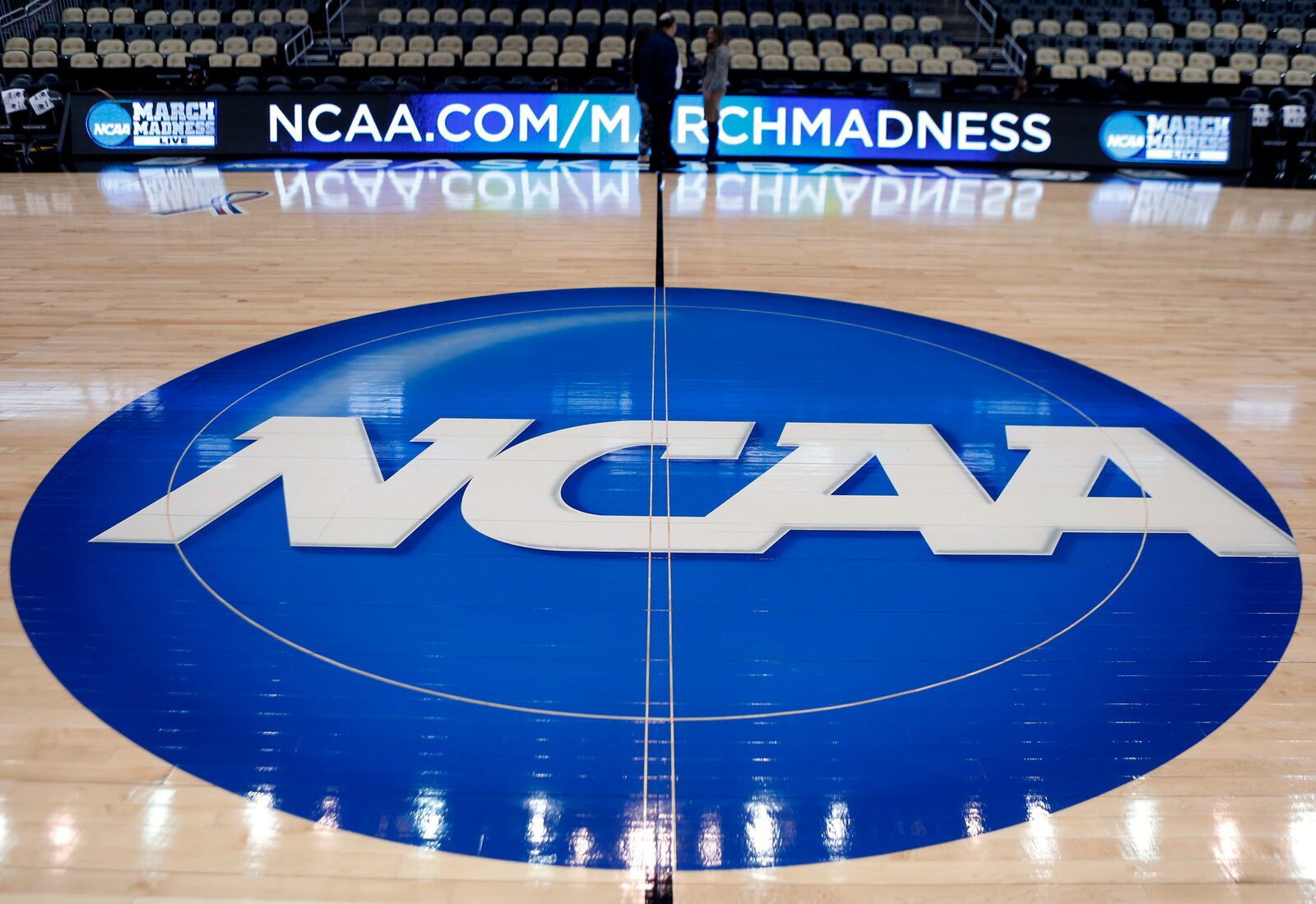 FILE - The NCAA logo is displayed at center court at The Consol Energy Center in Pittsburgh, March 18, 2015. (AP Photo/Keith Srakocic, File)