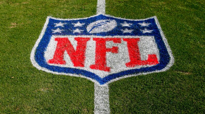 FILE - In this Nov. 4, 2018 file photo, the NFL logo is displayed on the field at the Bank of American Stadium before an NFL football game between the Tampa Bay Buccaneers and the Carolina Panthers in Charlotte, N.C. The NFL revealed Sunday, Aug. 23, 2020, that several positive COVID-19 tests were found a day earlier by one of its testing partners, and the Chicago Bears said they had nine false positives. (AP Photo/Nell Redmond, File)