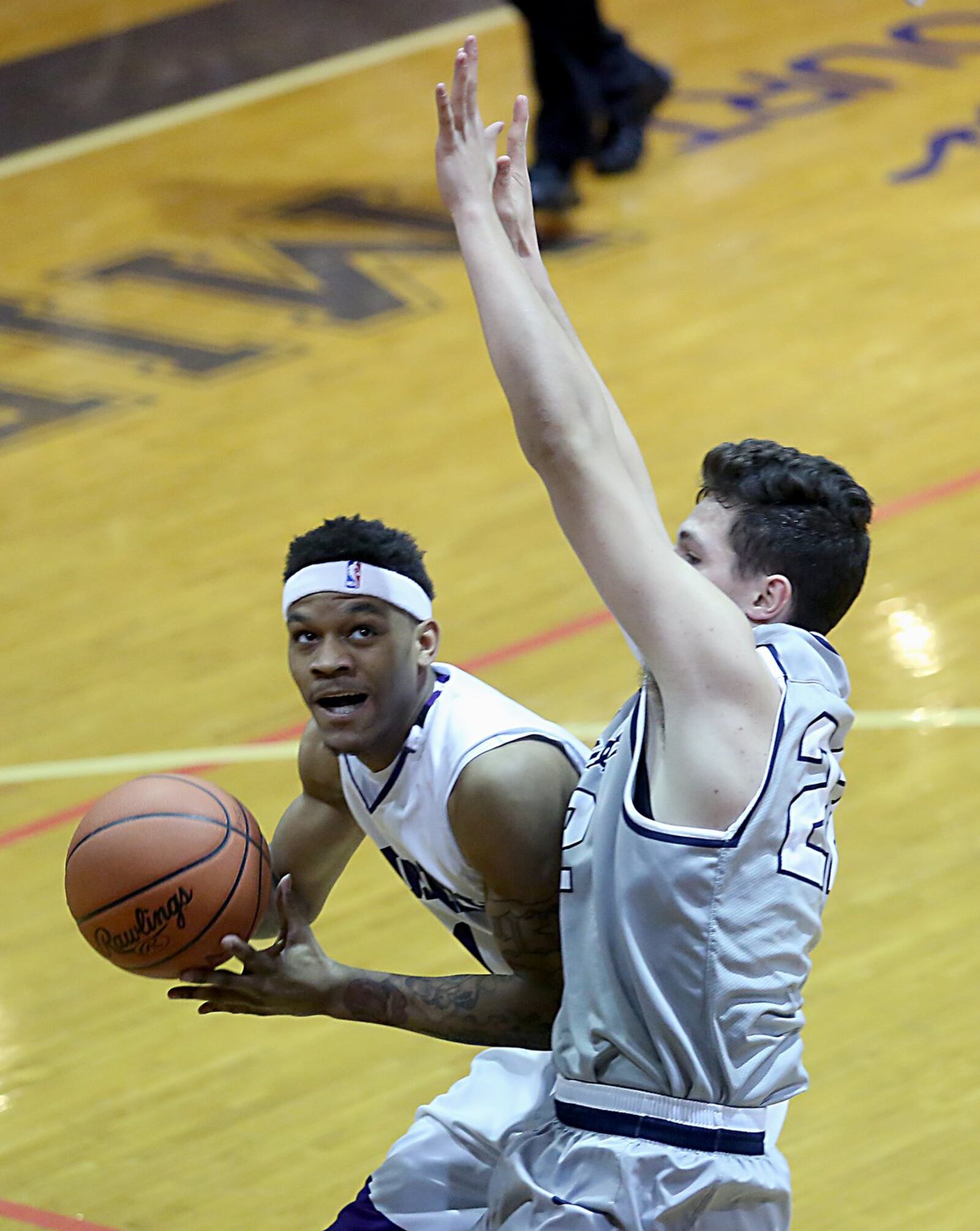 Middletown guard Nelson Rutledge drives on Fairmont center Dylan Crutchfield during their game at Wade E. Miller Gym in Middletown on Wednesday night. CONTRIBUTED PHOTO BY E.L. HUBBARD
