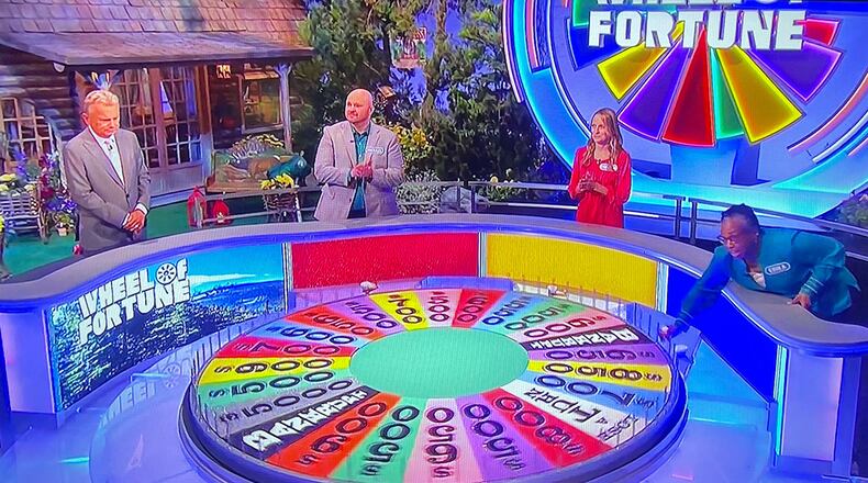 Erika Tate, an executive assistant with Engineering Directorate at Headquarters, Air Force Materiel Command, takes a turn at the wheel during her appearance on the TV game show “Wheel of Fortune” in March, which aired in May. U.S. AIR FORCE PHOTO/MICHELE DONALDSON