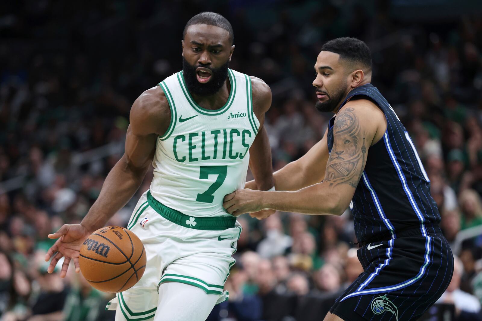 Boston Celtics' Jaylen Brown (7) drives past Orlando Magic's Cory Joseph during the first half in game 1 of a first-round NBA playoff basketball series Sunday, April 20, 2025, in Boston. (AP Photo/Michael Dwyer)