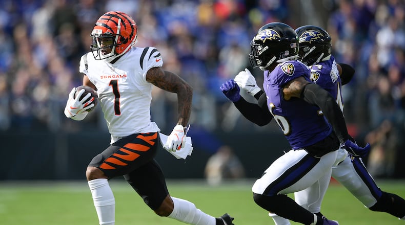 Cincinnati Bengals wide receiver Ja'Marr Chase (1) runs with the ball against Baltimore Ravens safety Chuck Clark (36) and cornerback Marlon Humphrey during the first half of an NFL football game, Sunday, Oct. 24, 2021, in Baltimore. (AP Photo/Nick Wass)