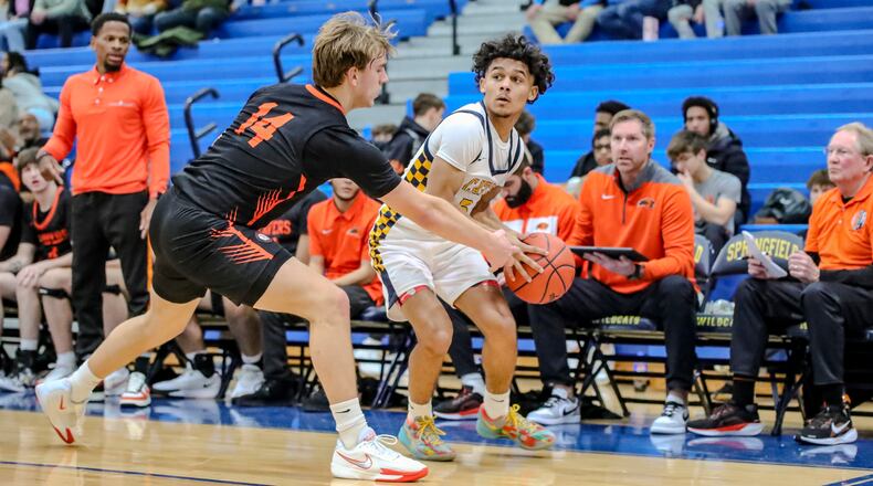 Springfield High School junior Charles Cunningham is guarded by Beavercreek's Owen Roether during their game on Friday, Jan. 14 at Springfield High School. CONTRIBUTED PHOTO BY MICHAEL COOPER