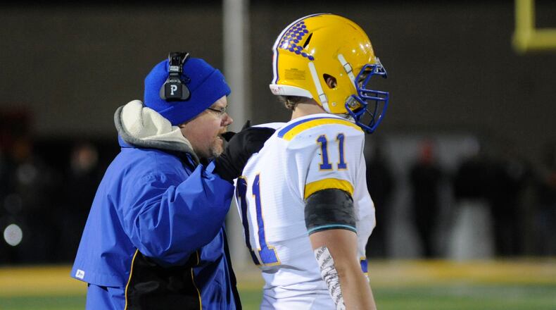 Division VI defensive player of the year Sam Huelsman huddles with Marion Local head coach Tim Goodwin. MARC PENDLETON / STAFF