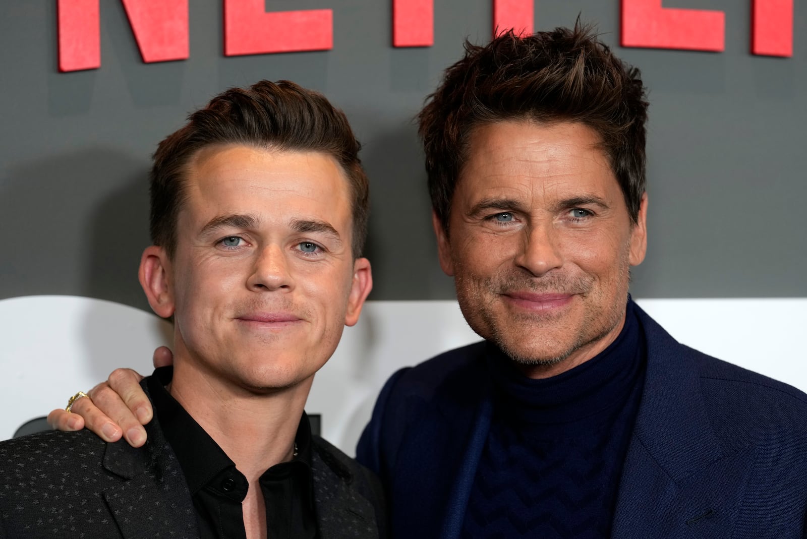 Rob Lowe, right, and his son John Owen, the co-stars, co-creators and executive producers of "Unstable," pose together at the premiere of the Netflix series, Thursday, March 23, 2023, at the Tudum Theatre in Los Angeles. (AP Photo/Chris Pizzello)