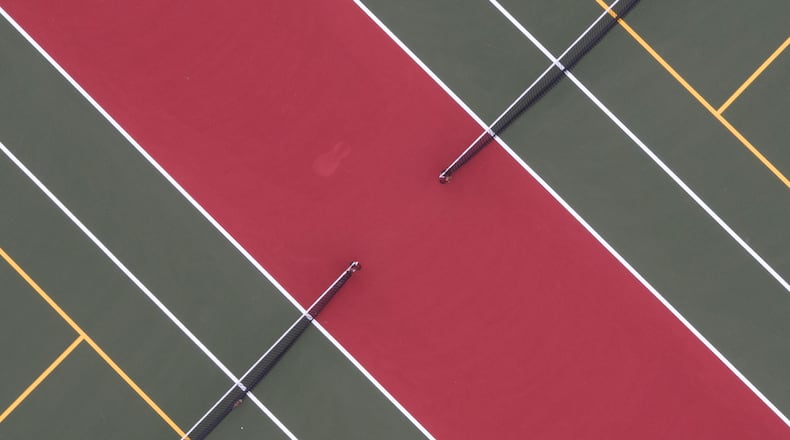 Symmetry of tennis courts in Dominick Lofino park in Beavercreek.  TY GREENLEES / STAFF