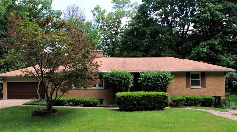 The brick ranch sits on a corner lot with a large side yard, terraced back yard with stone steps and paver-brick patio. It also has a 2-car garage. CONTRIBUTED PHOTOS BY KATHY TYLER