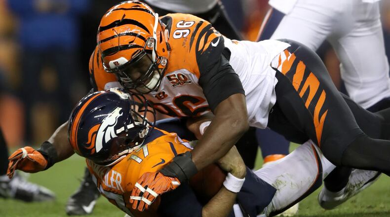 DENVER, CO - NOVEMBER 19: Quarterback Brock Osweiler #17 of the Denver Broncos is sacked by Carlos Dunlap #96 of the Cincinnati Bengals at Sports Authority Field at Mile High on November 19, 2017 in Denver, Colorado. (Photo by Matthew Stockman/Getty Images)