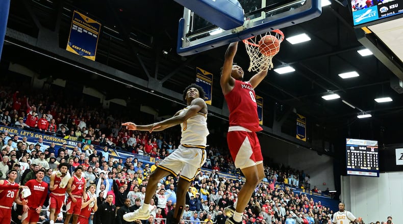 Miami forward Eian Elmer dunks against Kent State forward Rayvon Griffith during overtime of an NCAA college basketball game, Tuesday, Jan. 20, 2026, in Kent, Ohio. (AP Photo/David Dermer)