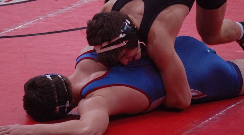 Southeastern’s Jesse Mitchell trues to turn Massillon Tuslaw’s Stephen Skeens during their D-III quarterfinal at the state wrestling tournament. John Cummings/CONTRIBUTED