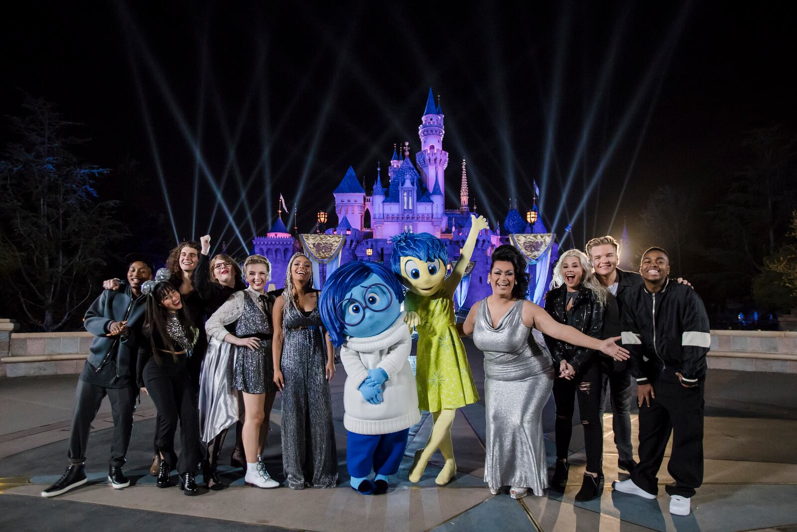 ANAHEIM, CA - APRIL 24:  "American Idol" Top 10 Contestants pose with Joy and Sadness from the Pixar film, "Inside Out," following a performance in front of Sleeping Beauty Castle at Disneyland park on Tuesday, April 24, 2018 in Anaheim, California.  This performance will air on ABC Sunday, April 29, during Disney Night on "American Idol." Joy and Sadness can be seen daily at Disneyland park in "Pixar Play Parade," part of Pixar Fest at Disneyland Resort, now through September 3, 2018.  (Photo by Joshua Sudock/Disneyland Resort via Getty Images)