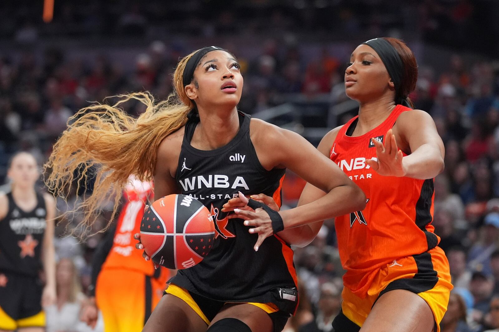 Chicago Sky's Angel Reese, left, shoots against Washington Mystics' Kiki Iriafen during the second half of a WNBA All-Star basketball game, Saturday, July 19, 2025, in Indianapolis. (AP Photo/Michael Conroy)