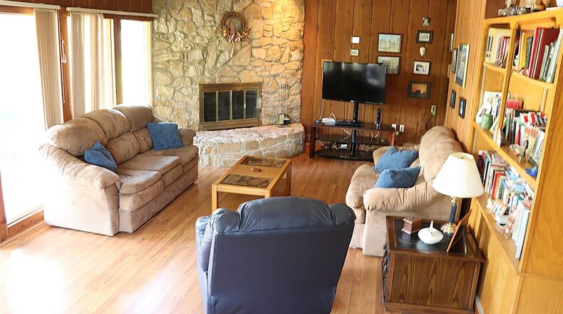 The addition off the back created a sunken recreation room with a stone, wood-burning fireplace, a wall of windows and sliding doors that open to the adjoining sunroom and a wet bar area complete with wrap-around, counter seating.
