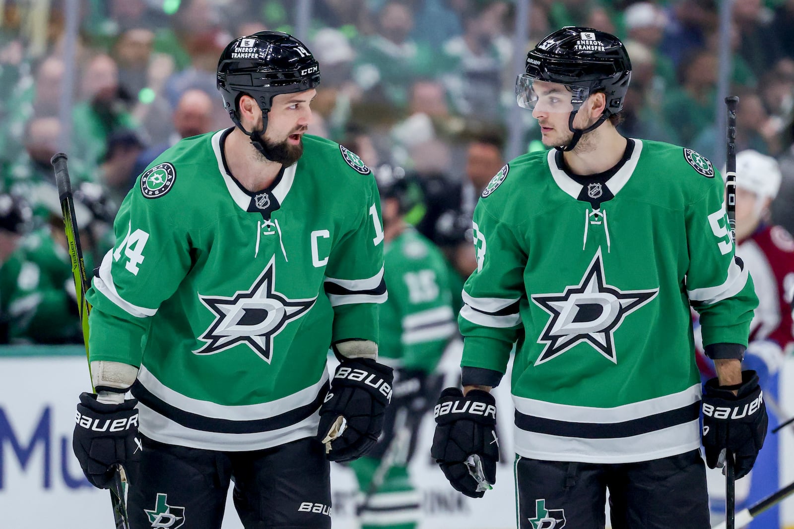 Dallas Stars left wing Jamie Benn, left, and center Wyatt Johnston, right, skate together before a face-off during the first period of Game 5 of a first-round NHL hockey playoff series against the Colorado Avalanche in Dallas, Monday, April 28, 2025. (AP Photo/Gareth Patterson)