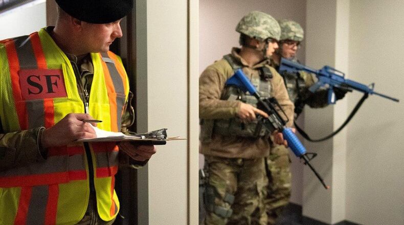 Master Sgt. Matthew Gillette, 88th Security Forces Squadron Training NCO in charge, observes as members of the 88th Security Forces Squadron participate in the active-shooter exercise on Wright-Patterson Air Force Base Feb. 26. Exercises are routinely held to streamline unit cohesion when responding to emergencies and test the base’s readiness to rapidly deploy. (U.S. Air Force photo/Senior Airman Emily Rupert)