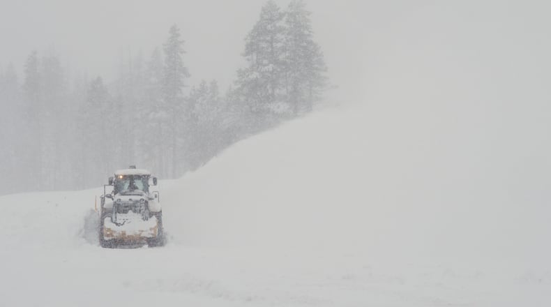 A road is cleared during a snow storm on Wednesday, Feb. 18, 2026 near Soda Springs, Calif. (AP Photo/Brooke Hess-Homeier)