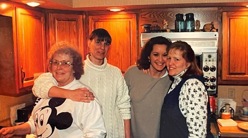 (Left to right): Karen Huelsman's mother, Arlene, sister Shelly, (Karen) and sister Sandy in the kitchen.