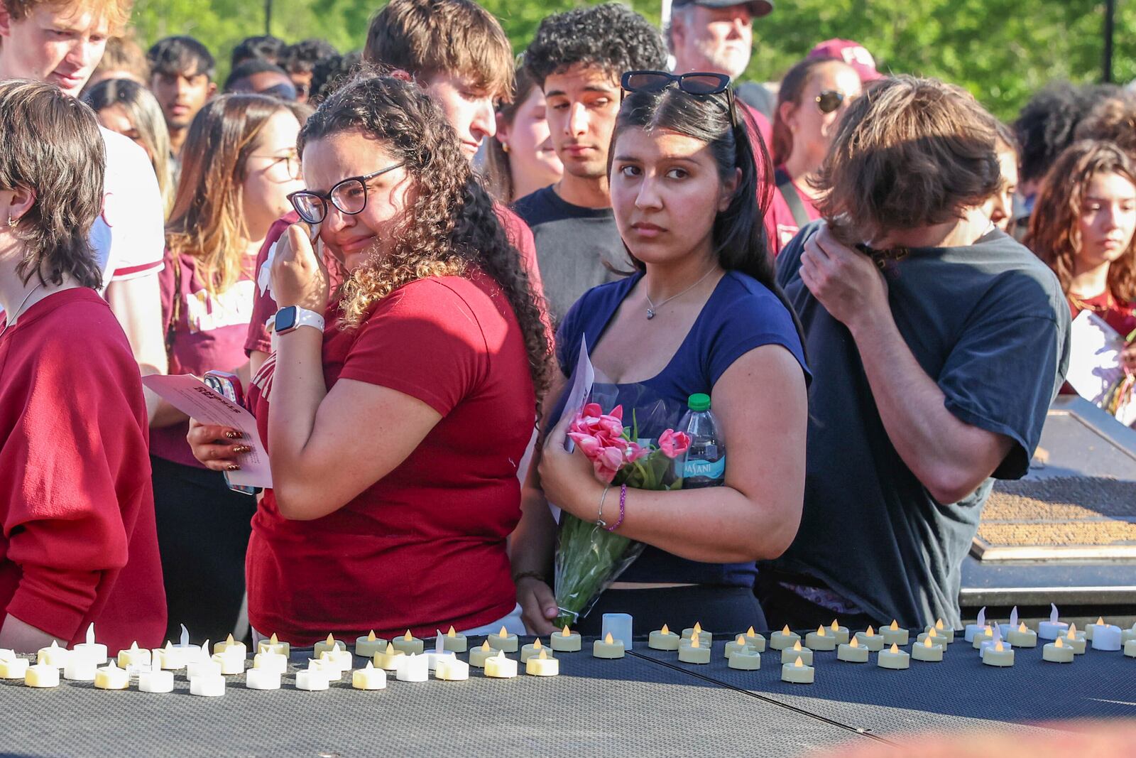 The day after an active shooter on campus Florida State students place electronic candles on a platform during a vigil on campus at Langford Green, Tallahassee, Fla., Friday, April 18, 2025. (AP Photo/Gary McCullough)