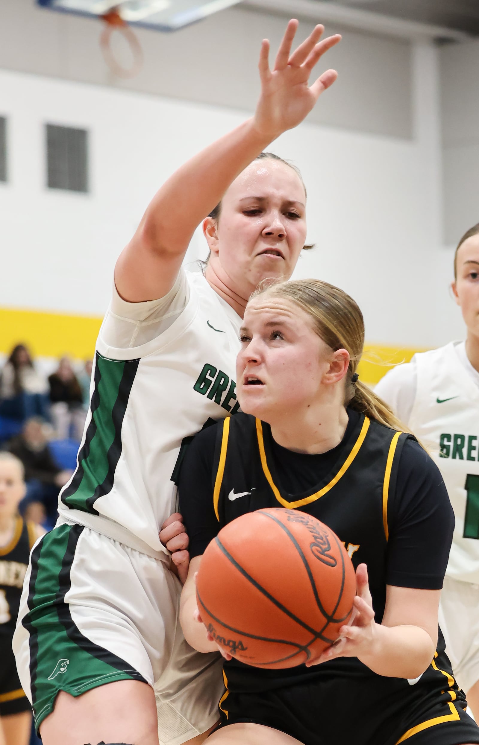 Sidney freshman guard Norah Kennedy drives with pressure from Greenville's Makenzie Legenzoff during a Division III district quarterfinal on Friday, Feb. 20 at Springfield High School. Kennedy scored seven points. BRYANT BILLING / STAFF