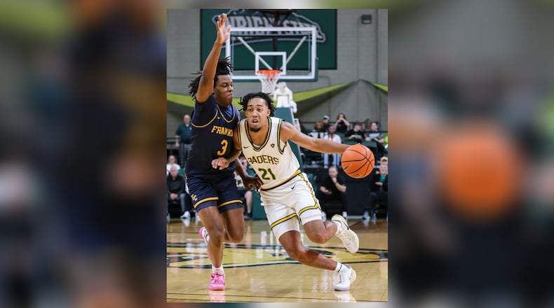 Wright State junior guard Logan Woods dribbles with pressure from Franklin College's Rohan Pearson during a season opener on Monday, Nov. 3 at Ervin J. Nutter Center in Fairborn. BRYANT BILLING/STAFF