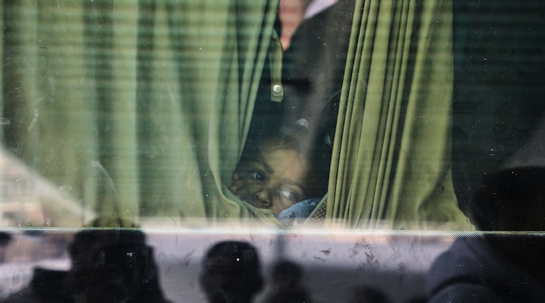 Juman Al-Najjar, a 3-year-old Palestinian patient, looks out from a vehicle with other patients in Khan Younis as they head to the Rafah crossing, leaving the Gaza Strip for medical treatment abroad, Monday, Feb. 2, 2026. (AP Photo/Abdel Kareem Hana)
