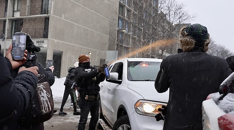 Activists confronted a group of Immigration and Customs Enforcement officers in the largely Somali neighborhood of Cedar-Riverside in Minneapolis, Tuesday, Dec. 9, 2025. (AP Photo/Mark Vancleave)