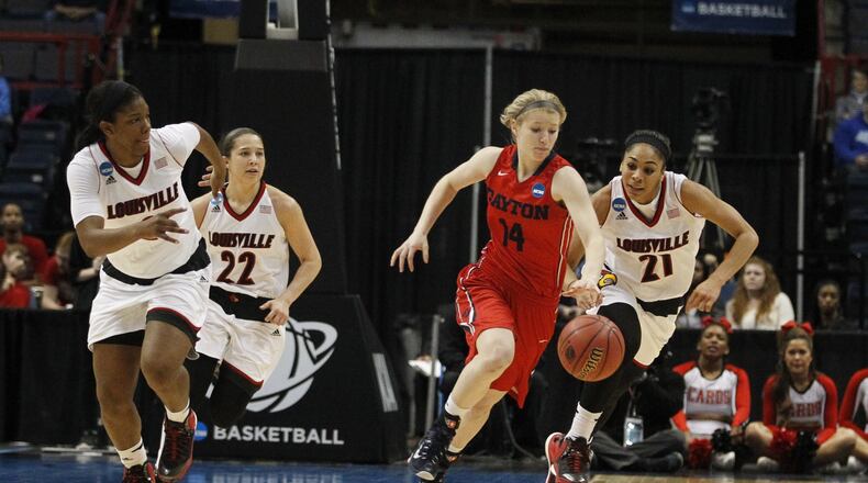 Dayton’s Jenna Burdette tries to elude three Louisville defenders in the third round of the NCAA tournament on Saturday, March 28, 2015, at the Times Union Center in Albany, N.Y. David Jablonski/Staff