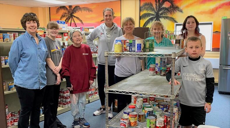 Volunteers collect canned goods for the Bellbrook Sugarcreek Community Support Center. CONTRIBUTED