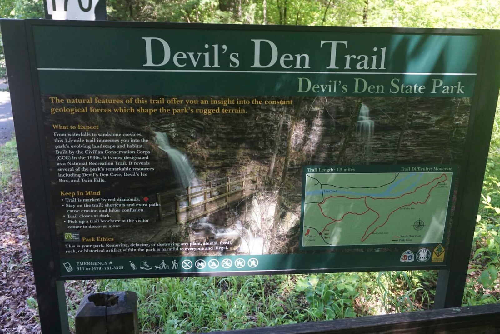 This May 2020 photo provided by Stephen O’Connell shows a sign for a hiking trail at Devil's Den State Park in West Fork, Ark. (Stephen O’Connell via AP)