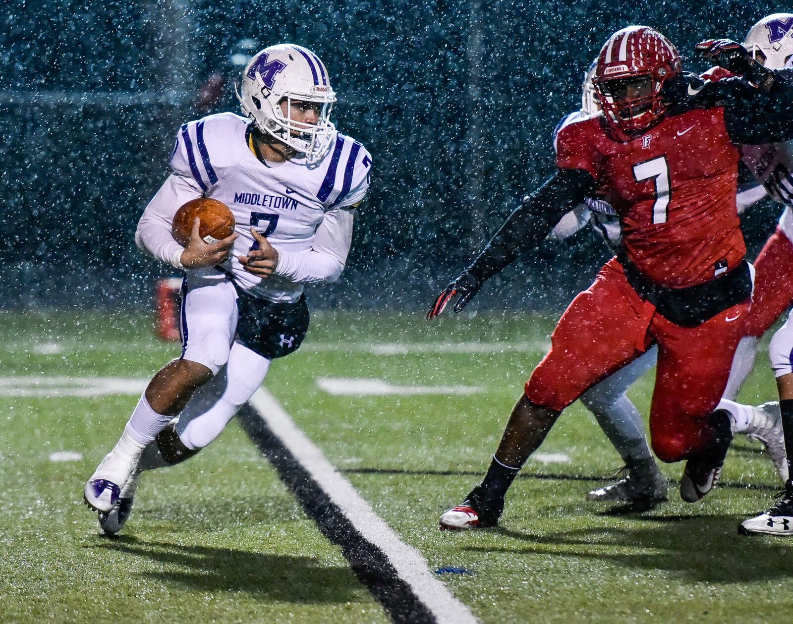 Middletown’s Blake Marshall carries the ball as Fairfield Malik Vann (7) pursues during a regular-season finale Oct. 27 at Fairfield Stadium. Marshall’s Middies lost 48-0 to finish 1-9. NICK GRAHAM/STAFF