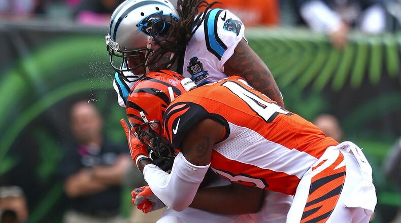 CINCINNATI, OH - OCTOBER 12: Kelvin Benjamin #13 of the Carolina Panthers is hit by George Iloka #43 of the Cincinnati Bengals while catching a pass for a touchdown during the first quarter at Paul Brown Stadium on October 12, 2014 in Cincinnati, Ohio. (Photo by Andy Lyons/Getty Images)