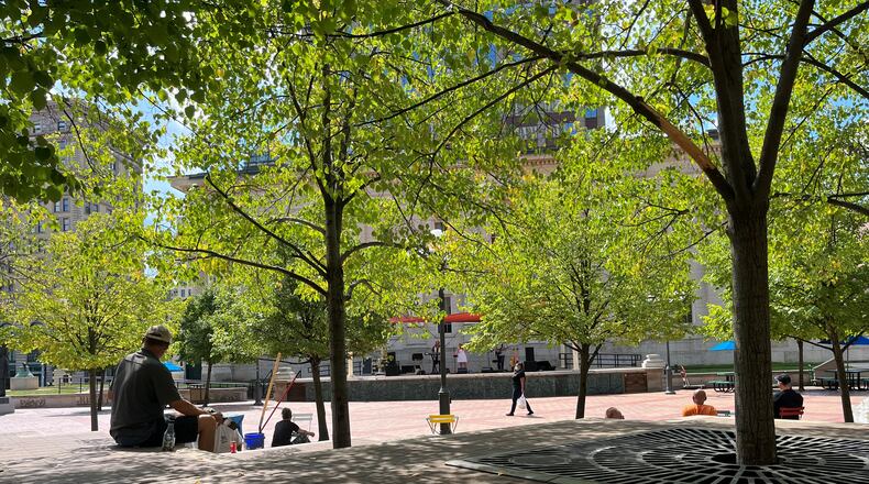 People gather on the terrace seating at Courthouse Square at lunchtime on Friday. CORNELIUS FROLIK / STAFF